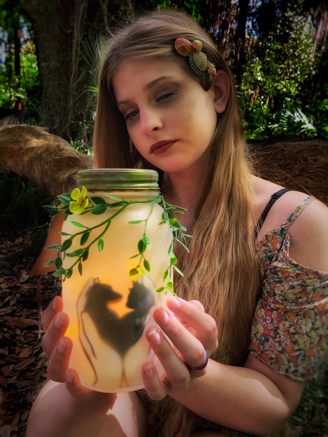 Girl holding dog and cat luminary jar.