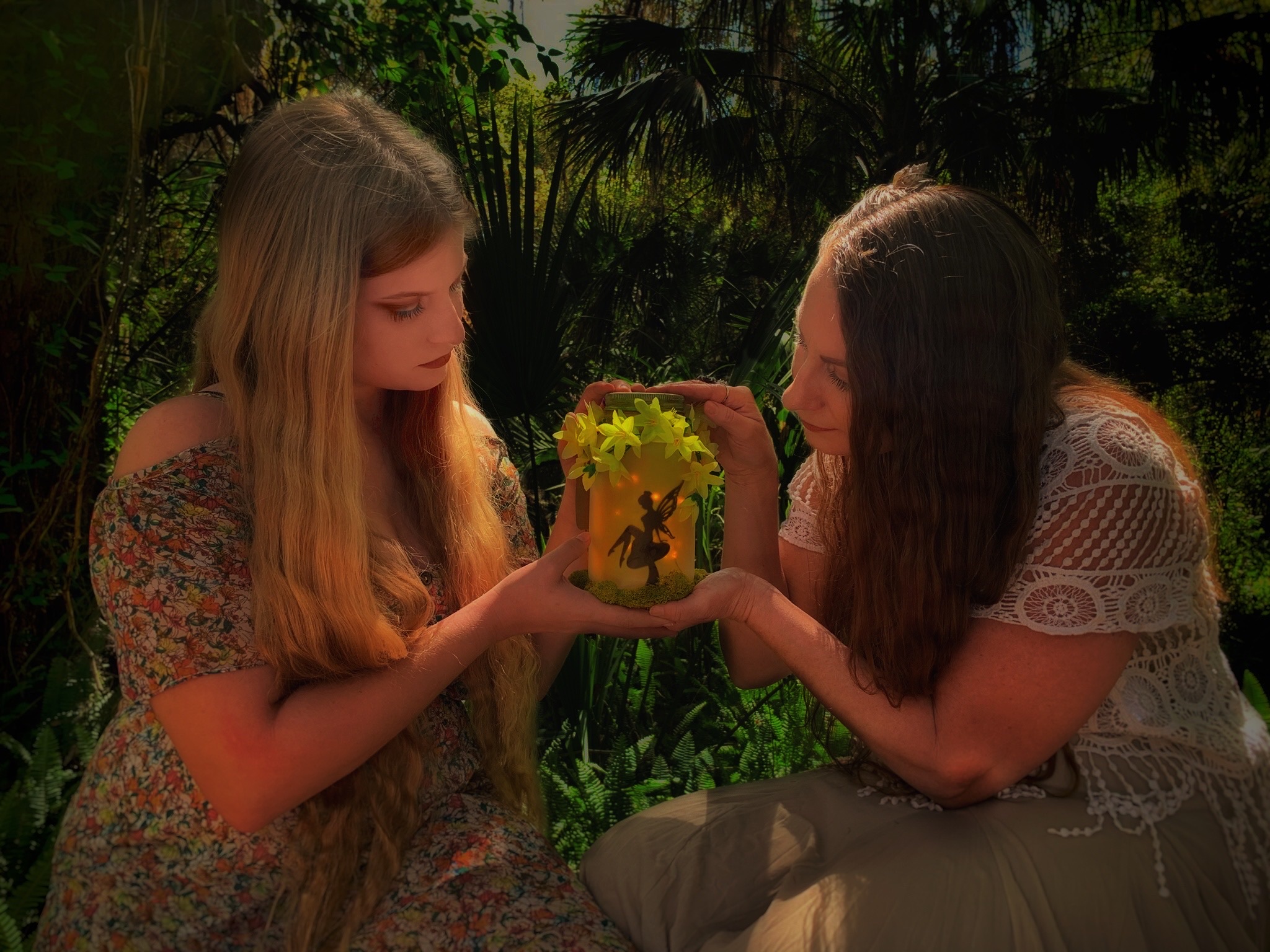 The artist and her daughter holding a luminary jar.